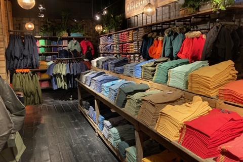 Superdry organic t-shirts on display shelves in store